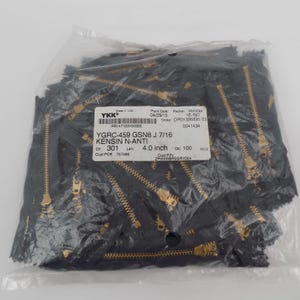 May include: A clear plastic bag filled with black zippers with gold-colored teeth. The label reads "YGRC-459 GSN8 J 7/16 KENSIN N-ANTI" and "4.0 inch". The bag contains 100 pieces.