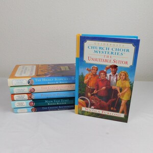 May include: A stack of 6 paperback books with colorful covers and the title "Church Choir Mysteries" on the spine. The books are titled "The Highly Suspicious House", "The Coin Conspiracy", "Puzzle in Patchwork", "Maim That Tune!", "The Greedy Auctioneer", and "The Unsuitable Suitor".