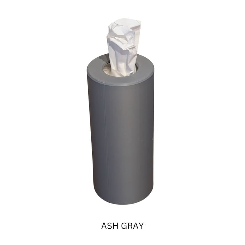 May include: A grey cylindrical tissue box dispenser with a white tissue peeking out of the top. The text "ASH GRAY" is printed below the dispenser.