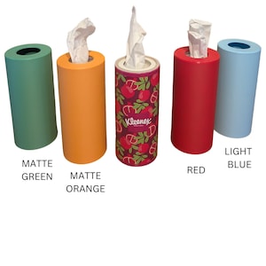 May include: Five tissue box holders in different colours: matte green, matte orange, red, light blue, and a patterned holder with a red background and a white "Kleenex" logo.