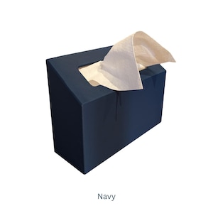 May include: A navy blue tissue box holder with a white tissue box partially pulled out. The tissue box holder has a square shape with a slanted top.