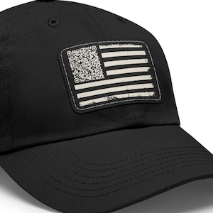 May include: Black baseball cap with a distressed American flag patch. The patch features a QR code in place of the stars and white and black stripes. The cap has a curved brim and a top button.