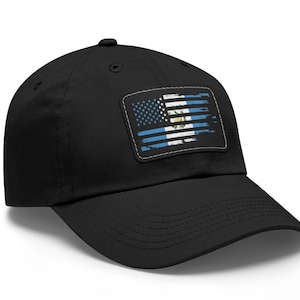 May include: A black baseball cap with a distressed American flag patch featuring the flag of Guatemala. The patch is sewn onto the front of the cap.