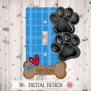 May include: A light blue plaid switch plate with a white switch and two black paw prints. A brown bone with the text "Yum Bone" and a red heart are also featured. The bottom of the plate reads "DIGITAL DESIGN".