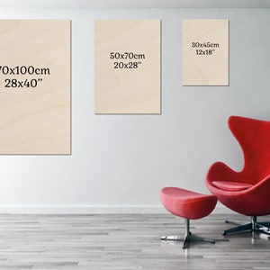 a red chair sitting in front of a white wall