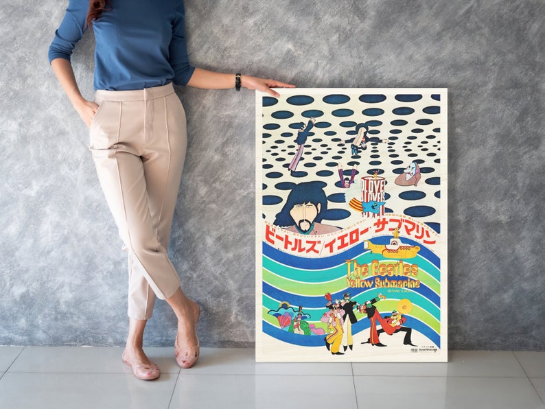a woman standing next to a poster on a wall