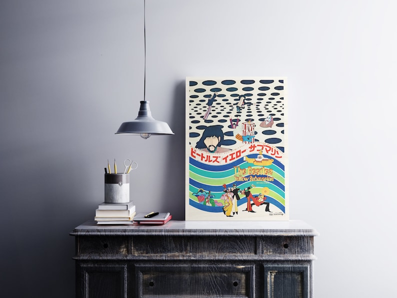 a poster on a table next to a lamp