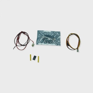 May include: A collection of electronic components. It includes a bundle of red and black wires, a bundle of yellow and brown wires, two yellow connectors, a black connector, and a component sealed in a clear plastic bag.