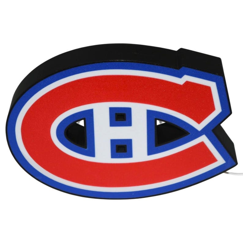 May include: A black, red, white, and blue Montreal Canadiens logo. The logo is in the shape of a large letter "C" with a smaller "H" inside. The logo is a light-up sign.