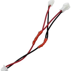 May include: A pair of electrical connectors with red and black wires. The wires are covered in orange heat shrink tubing and terminate in white plastic connectors. The background is plain white.