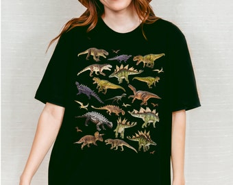 May include: A black t-shirt with a graphic print of various dinosaurs in shades of green, brown, and gray.