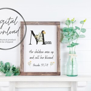 Könnte beinhalten: Ein druckbarer digitaler Download eines gerahmten Schildes mit einem floralen Design und dem Wort "Mama" mit dem Zitat "Ihre Kinder stehen auf und nennen sie gesegnet. Sprichwörter 31:28"
