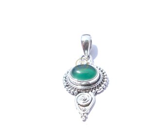 May include: A silver pendant with an oval, green gemstone at the center. The gemstone is surrounded by a detailed, ornate silver setting. The pendant has a loop at the top for a chain and a decorative spiral design at the bottom.