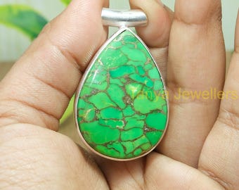 May include: A teardrop-shaped pendant with a green turquoise stone set in sterling silver.
