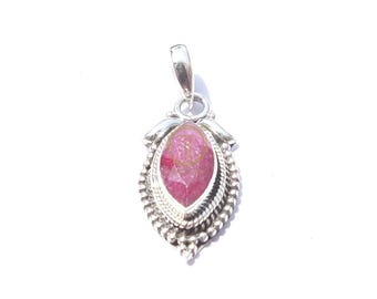 May include: A silver pendant featuring a large, oval pink gemstone. The gemstone is set in a detailed silver frame with a beaded border and decorative accents. The pendant has a loop for a chain.