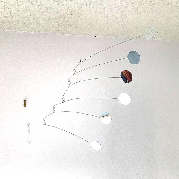mirror mobile sculpture, with closeup of weighty Sinehe spherical faceted prism