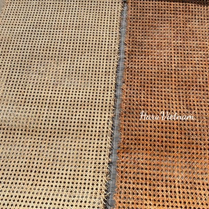 May include: Close-up of two sections of woven cane webbing. One section is a light beige color, and the other is a warm brown. The webbing has a repeating pattern of small, evenly spaced holes. The text "Haru Vietnam" is visible in the lower right corner.