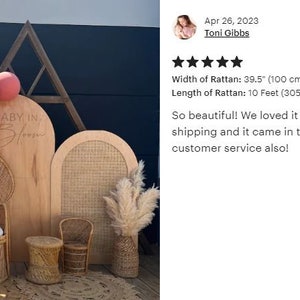 May include: A wooden backdrop with the text "BABY IN BLOOM" is decorated with pink balloons. A woman in a pink dress stands in front of the backdrop. The rattan width is 39.5 inches (100 cm), and the length is 10 feet (305 cm).