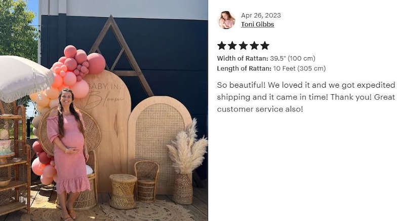 May include: A wooden backdrop with the text "BABY IN BLOOM" is decorated with pink balloons. A woman in a pink dress stands in front of the backdrop. The rattan width is 39.5 inches (100 cm), and the length is 10 feet (305 cm).
