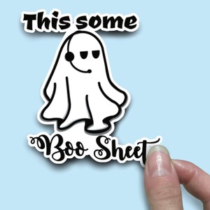 May include: A white ghost wearing a headset with the text "This some Boo Sheet" in black.