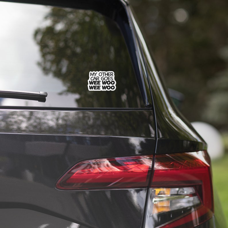 May include: A black car with a sticker on the back window that says "My other car goes wee woo wee woo".