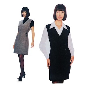 May include: Two women wearing sleeveless dresses. The dress on the left is gray and has a wrap style. The dress on the right is black and has a V-neckline.