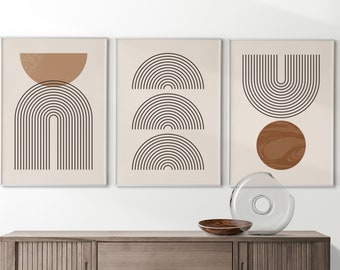 May include: Three framed prints with abstract geometric designs in black and brown on a cream background. The prints feature arches, circles, and lines.