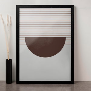 May include: A framed print with a minimalist design featuring a brown half-circle shape against a white background with thin horizontal lines.
