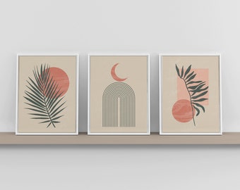 May include: Three framed prints with abstract designs in shades of pink, brown, and green. The prints feature a palm leaf, a crescent moon, an arch, and a circle.