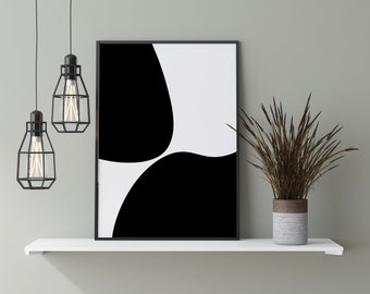 Op de afbeelding: Een zwart-witte abstracte print in een zwart frame hangt aan een wit rek met twee zwarte hanglampen en een gedroogde plant in een grijze en bruine pot.