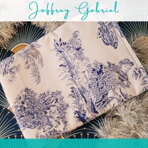 May include: A white fabric with a blue and white floral pattern. The fabric features a repeating design of stylised trees, flowers, and birds.