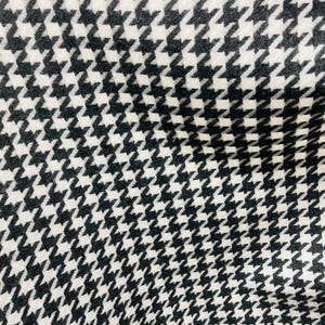 May include: Black and white houndstooth fabric with a diagonal pattern.