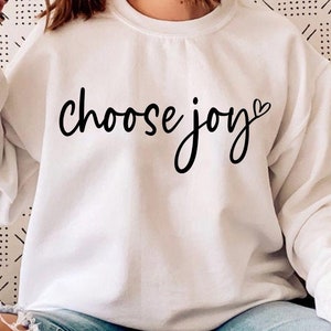 May include: White sweatshirt with the text "choose joy" in black script with a small heart symbol.