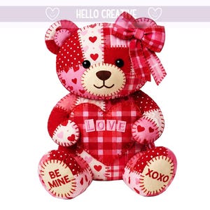 May include: A patchwork teddy bear in shades of red and pink, with a heart-shaped chest that reads "LOVE". The bear has a bow and the words "BE MINE" and "XOXO" on its paws. The text "HELLO CREATIVE" is at the top.