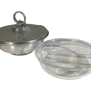 May include: A silver serving bowl with a lid and a glass divided serving dish. The bowl has a beaded edge and a ring handle on the lid.