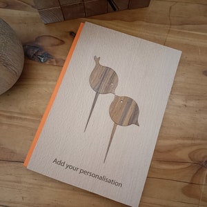 May include: A wooden card with an orange border and two wooden birds kissing. The card says "Add your personalisation".