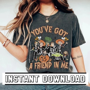 May include: Dark gray t-shirt featuring a Halloween-themed graphic with the text "YOU'VE GOT A FRIEND IN ME." The design includes cartoon characters dressed as skeletons. The words "INSTANT DOWNLOAD" are at the bottom.