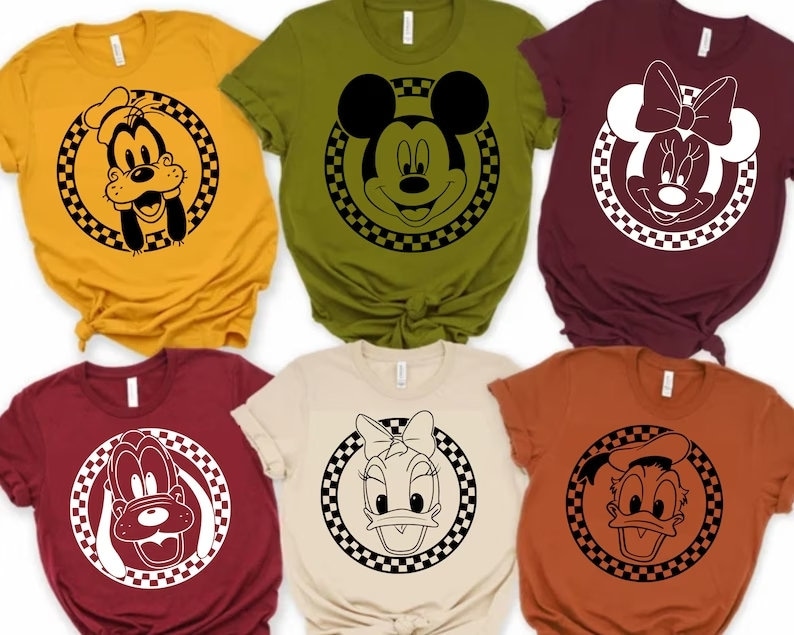 May include: Six different t-shirts featuring various Disney characters in black and white. The characters are Mickey Mouse, Minnie Mouse, Donald Duck, Goofy, and Daisy Duck. Each character is surrounded by a checkered circle.