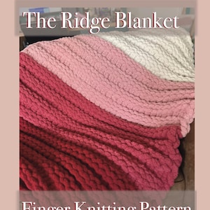 May include: A handmade, finger-knitted blanket in shades of red, pink, and white. The Ridge Blanket pattern is displayed, with the text "Finger Knitting Pattern" and YouTube handle @TheKnottedOtter. The blanket has a textured, chunky knit.