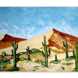 May include: An oil painting on canvas depicting a desert landscape with tall green saguaro cacti in the foreground. The background features large, textured sand dunes in shades of tan and brown under a bright blue sky with visible brushstrokes.