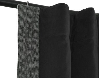 May include: Black and grey patterned curtains with a herringbone design. The curtains are hanging on a black rod.