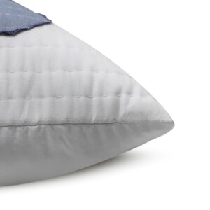 A standard sham, measuring 20" x 26" (50 x 66 cm), with the blue and white appliqué pattern. This handmade cotton sham adds a touch of elegance to any bedding ensemble.