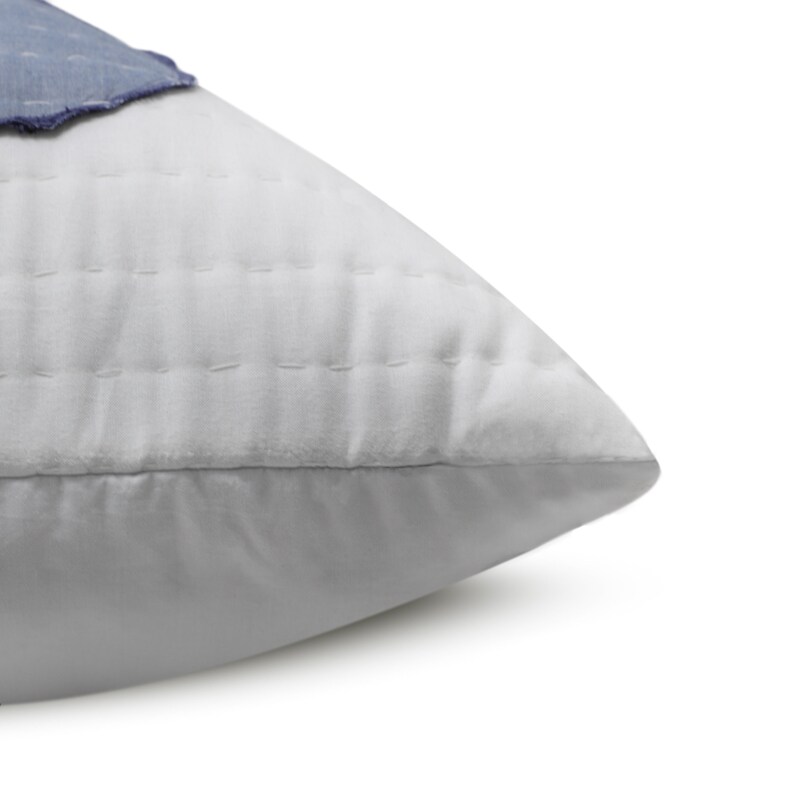 A standard sham, measuring 20" x 26" (50 x 66 cm), with the blue and white appliqué pattern. This handmade cotton sham adds a touch of elegance to any bedding ensemble.