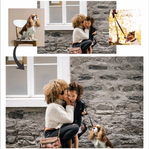 A woman with curly brown hair is whispering to a young girl with brown hair. The woman is wearing a white sweater, black pants, and a brown purse. The girl is wearing a black jacket and a pink skirt. A brown and white dog is sitting on the ground. The background is a gray brick wall.