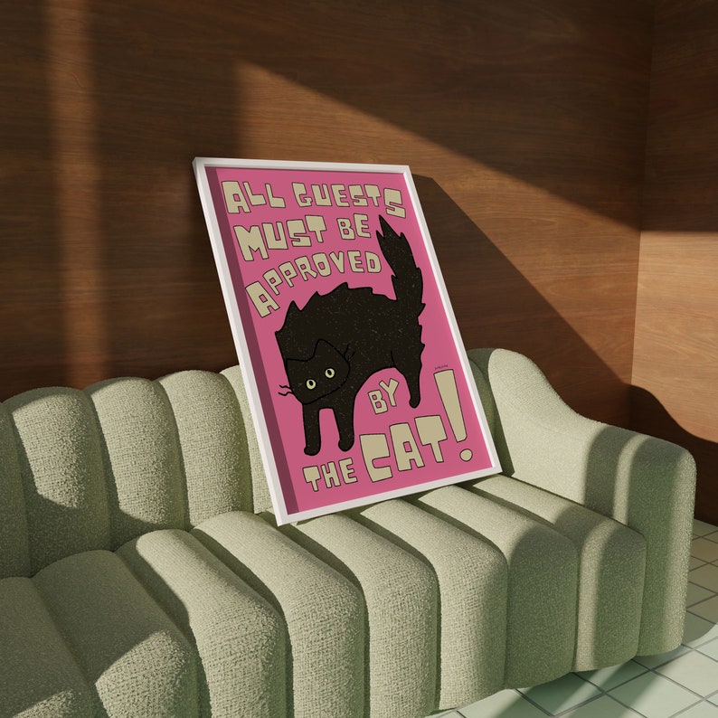 May include: A pink and white poster with a black cat illustration and the text "All guests must be approved by the cat!"