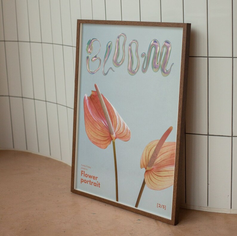 May include: A framed print with a light blue background featuring the word "bloom" in iridescent letters. Two pink and orange anthurium flowers are depicted in the print. The text "Flower portrait" is printed below the flowers. The print is labeled "[2/5]".