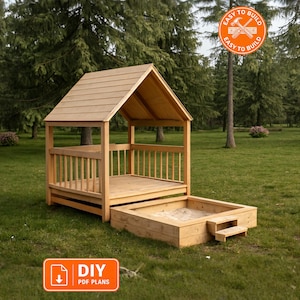 May include: A wooden playhouse with a gabled roof and an attached rectangular sandbox featuring a small step. The structure is made of light-colored wood. An orange circular badge reads EASY TO BUILD and an orange rectangular badge reads DIY PDF PLANS.
