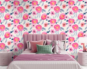 May include: A bedroom with a floral wallpaper featuring pink watercolor flowers and blue leaves. The bed has a pink headboard, pillows, and a pink bedspread. Two pink nightstands flank the bed, each with a lamp.