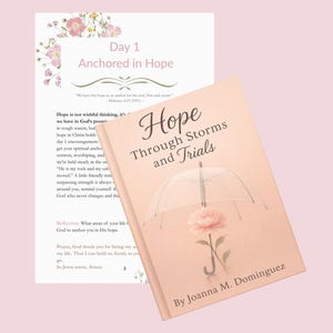 May include: A book titled "Hope Through Storms and Trials" with a pink cover featuring an umbrella and a rose illustration. Beside it is a page with the text "Day 1 Anchored in Hope" and floral accents. The background is a soft pink.