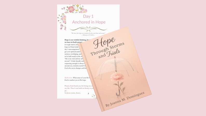 May include: A book titled "Hope Through Storms and Trials" with a pink cover featuring an umbrella and a rose illustration. Beside it is a page with the text "Day 1 Anchored in Hope" and floral accents. The background is a soft pink.